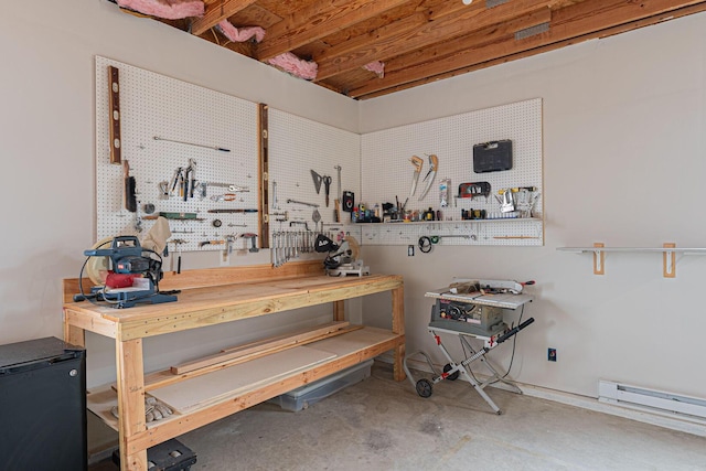 basement featuring a workshop area and a baseboard radiator