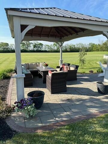 view of patio featuring an outdoor living space and a gazebo