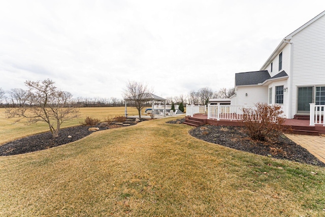 view of yard featuring a deck and a gazebo