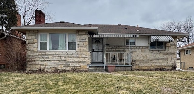 view of front of house with stone siding, a shingled roof, a chimney, and a front lawn