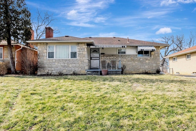 single story home featuring stone siding, a chimney, and a front yard