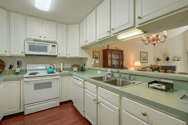 6922 Greensview Village Dr, Canal Winchester, OH 43110 - kitchen with white appliances, a sink, light countertops, dark wood finished floors, and a chandelier