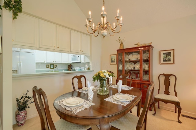 6922 Greensview Village Dr, Canal Winchester, OH 43110 - dining area featuring a chandelier, light colored carpet, lofted ceiling, and baseboards
