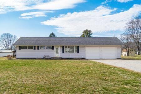 single story home featuring driveway, an attached garage, and a front lawn