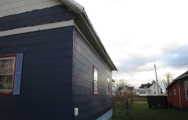 view of home's exterior featuring fence