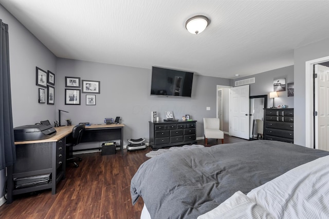 bedroom featuring dark wood-style floors, visible vents, and a textured ceiling