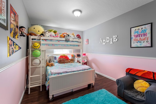 bedroom with baseboards and wood finished floors