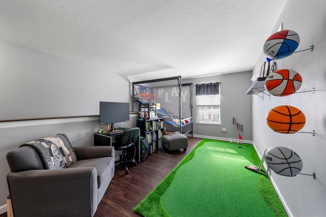 recreation room with a textured ceiling, wood finished floors, and baseboards