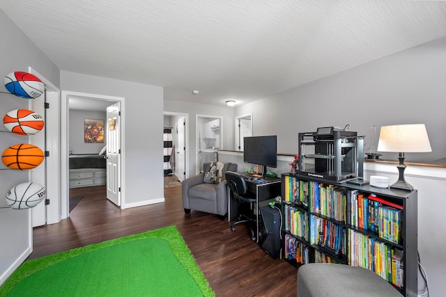 game room with a textured ceiling, baseboards, and wood finished floors