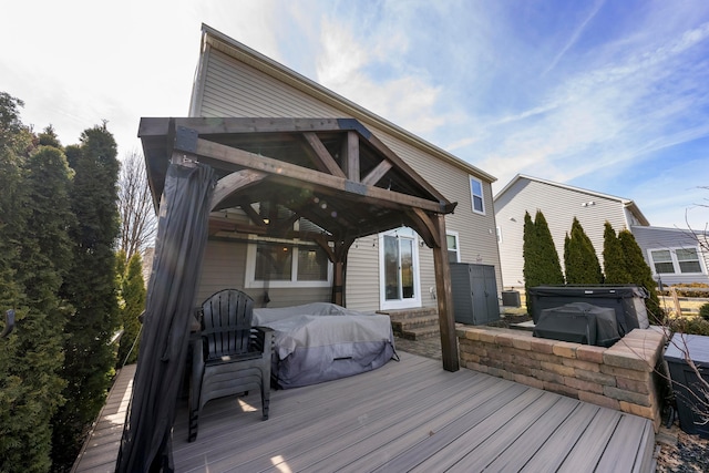 wooden deck with a hot tub