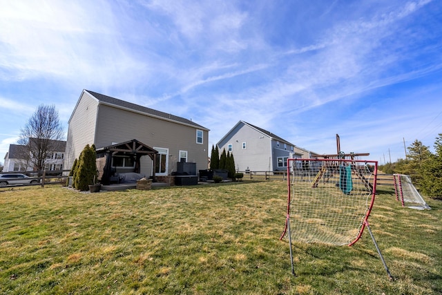 exterior space featuring a playground, a lawn, a gazebo, a patio area, and fence