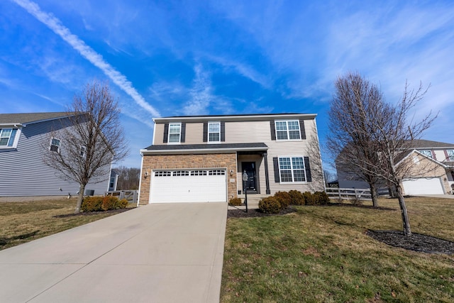 traditional home with an attached garage, concrete driveway, and a front yard