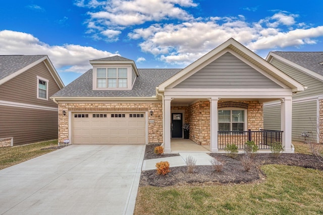 craftsman house with covered porch, roof with shingles, an attached garage, and concrete driveway