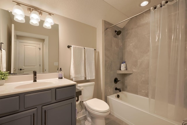 full bathroom featuring toilet, shower / bath combo with shower curtain, a textured ceiling, vanity, and tile patterned flooring