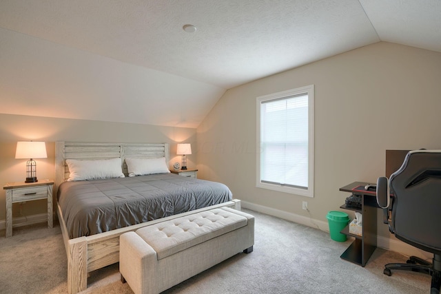 carpeted bedroom with lofted ceiling, a textured ceiling, and baseboards