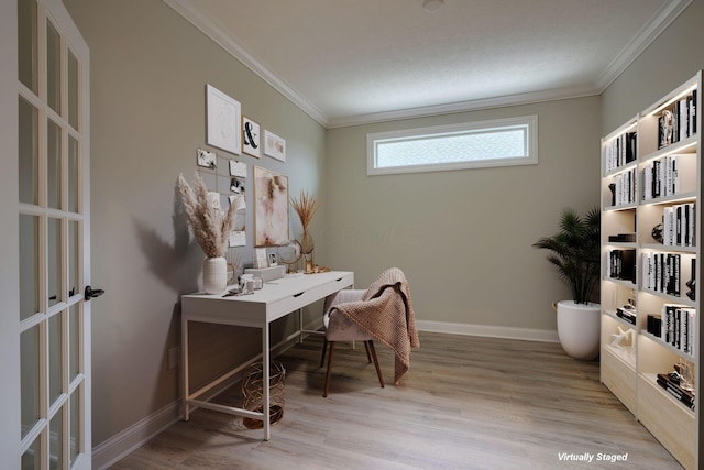 office with baseboards, light wood-type flooring, and crown molding