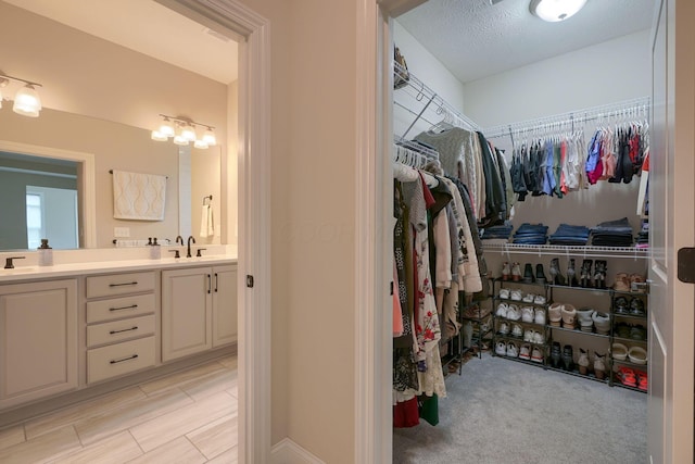 spacious closet featuring a sink