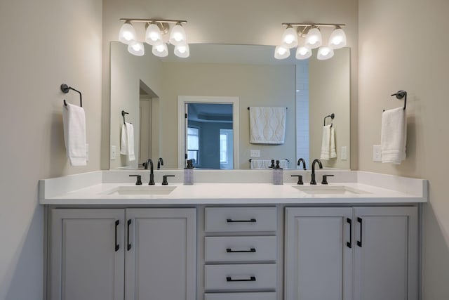 full bath featuring double vanity and a sink