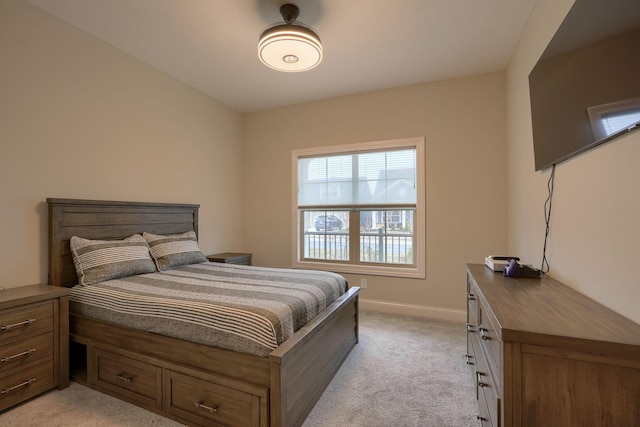 bedroom featuring baseboards and light colored carpet