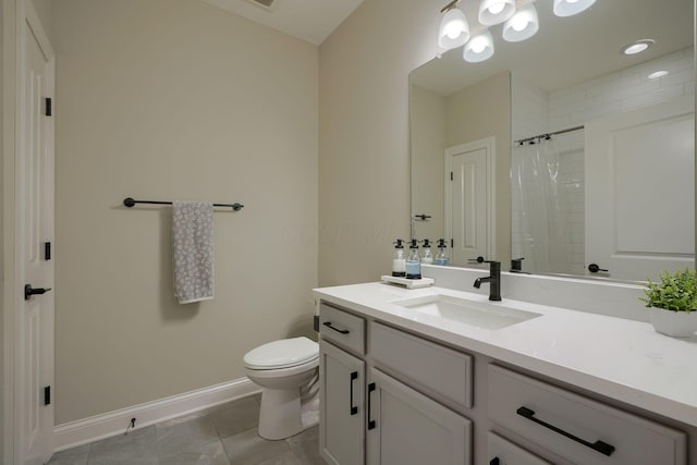 bathroom featuring toilet, a tile shower, vanity, tile patterned flooring, and baseboards