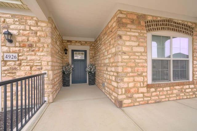 view of exterior entry with a porch