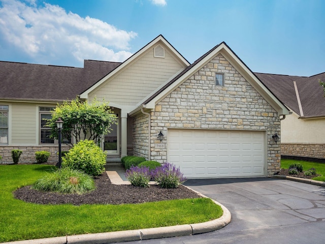 7969 Linksview Cir, Westerville, OH 43082 - view of front of home featuring stone siding, asphalt driveway, a garage, and roof with shingles