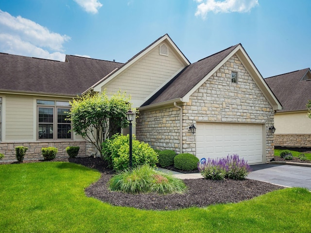 7969 Linksview Cir, Westerville, OH 43082 - view of front of house with stone siding, driveway, a shingled roof, and a garage