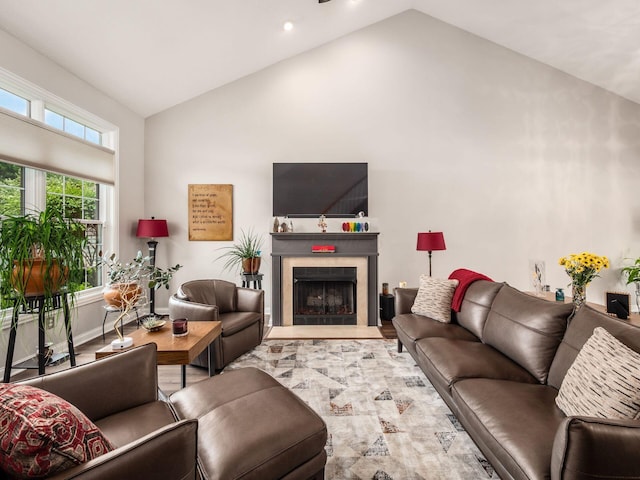 7969 Linksview Cir, Westerville, OH 43082 - living room with high vaulted ceiling, wood finished floors, a tiled fireplace, and recessed lighting