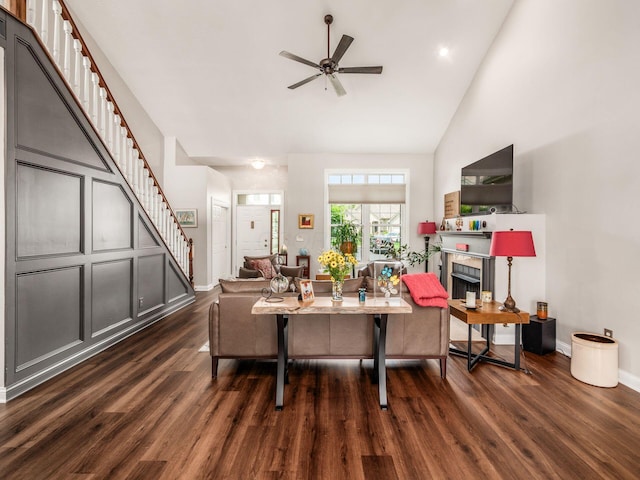 7969 Linksview Cir, Westerville, OH 43082 - living area with stairs, wood finished floors, a ceiling fan, high vaulted ceiling, and a fireplace