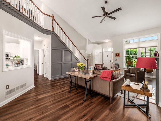 7969 Linksview Cir, Westerville, OH 43082 - living room featuring a high ceiling, stairway, dark wood finished floors, and a ceiling fan