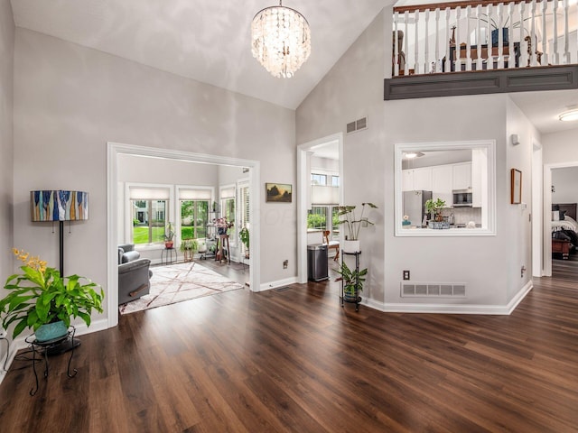 7969 Linksview Cir, Westerville, OH 43082 - foyer entrance with high vaulted ceiling, a chandelier, and wood finished floors