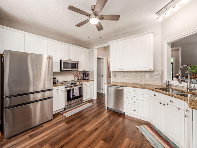 7969 Linksview Cir, Westerville, OH 43082 - kitchen with stainless steel appliances, ceiling fan, dark wood-type flooring, white cabinets, and tasteful backsplash