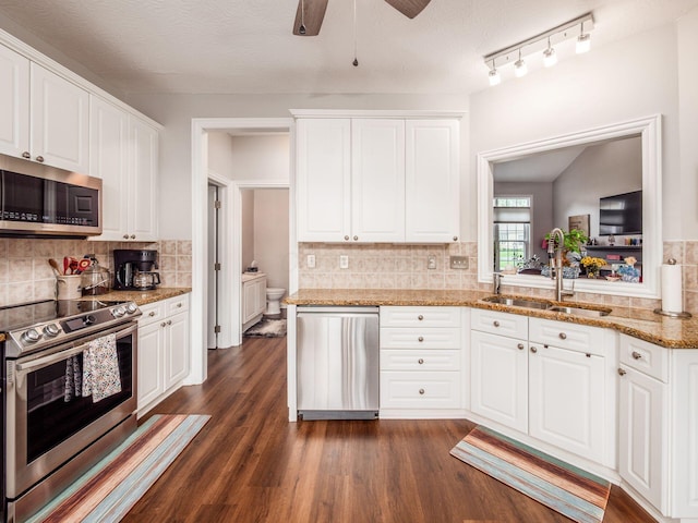 7969 Linksview Cir, Westerville, OH 43082 - kitchen with stainless steel appliances, a ceiling fan, decorative backsplash, and white cabinets