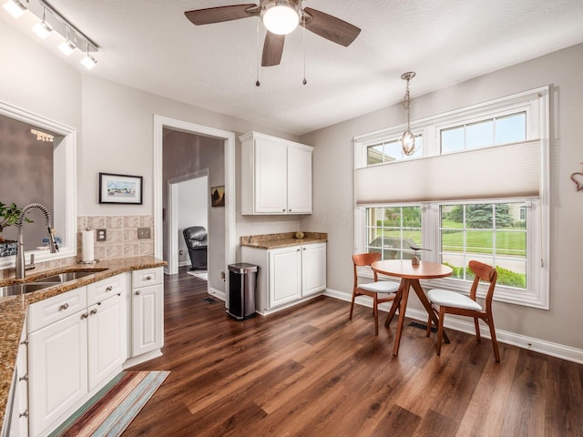 7969 Linksview Cir, Westerville, OH 43082 - kitchen featuring dark wood-style flooring, ceiling fan, white cabinets, and light stone counters