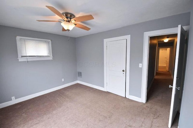 unfurnished bedroom featuring ceiling fan, carpet, and baseboards