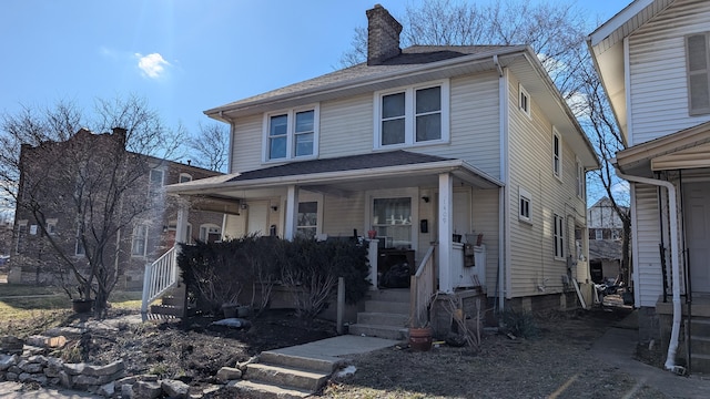 1411 N 5th St, Columbus, OH 43201 - traditional style home featuring a shingled roof, covered porch, and a chimney