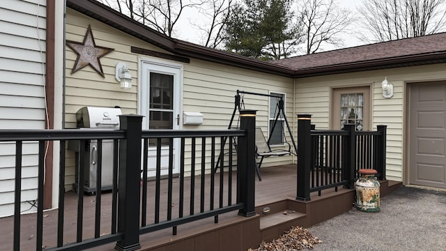 deck with a garage and area for grilling