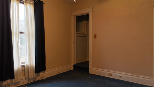 spare room with baseboards