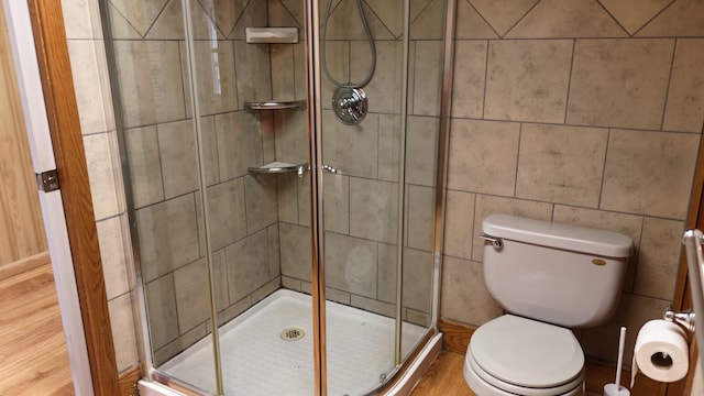 bathroom featuring a shower stall and toilet