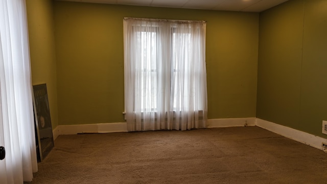 empty room with baseboards and carpet floors