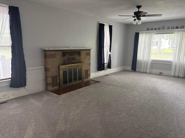324 E Main St, Cardington, OH 43315 - unfurnished living room featuring carpet, a ceiling fan, and a stone fireplace