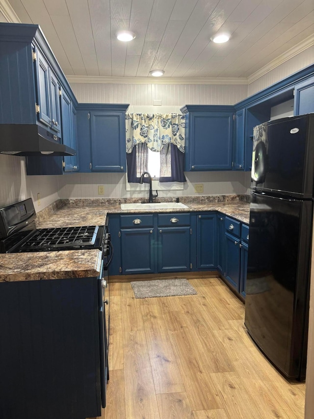 324 E Main St, Cardington, OH 43315 - kitchen with black appliances, blue cabinets, under cabinet range hood, ornamental molding, and light wood-type flooring