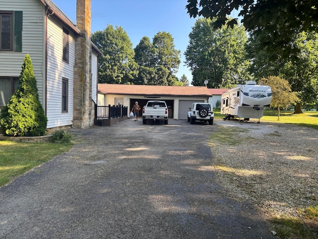 324 E Main St, Cardington, OH 43315 - view of parking / parking lot with a garage and asphalt driveway