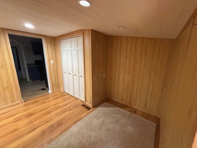324 E Main St, Cardington, OH 43315 - unfurnished bedroom with light wood-style flooring, wooden walls, a closet, and recessed lighting