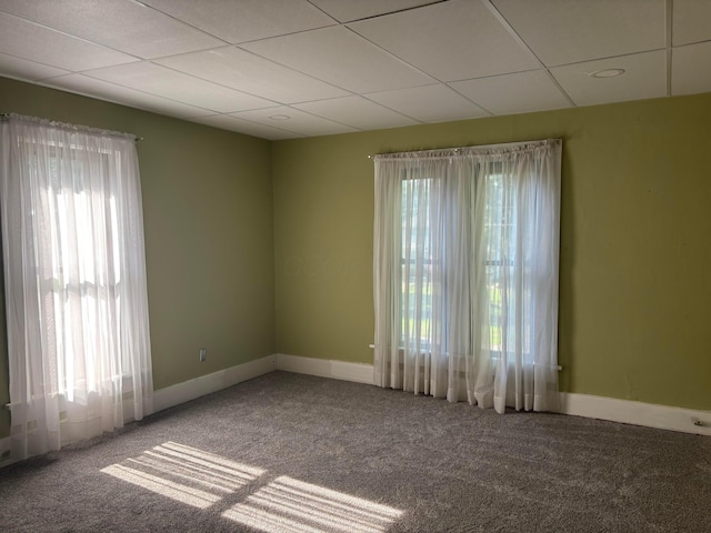324 E Main St, Cardington, OH 43315 - carpeted empty room with healthy amount of natural light and a drop ceiling