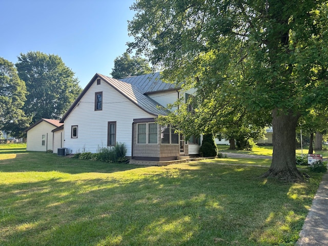 324 E Main St, Cardington, OH 43315 - view of side of home with a yard, a sunroom, and a metal roof