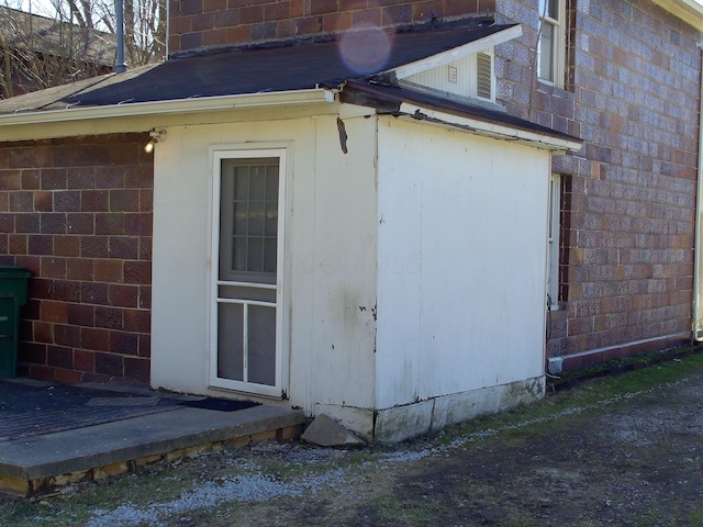 view of side of home with brick siding