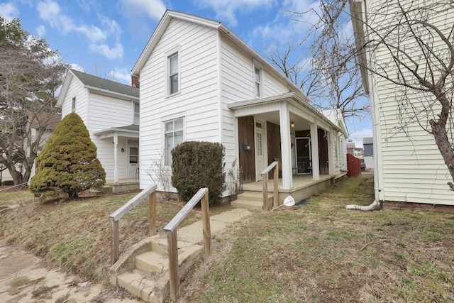 view of front of house with a front lawn and a porch