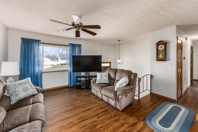 living room with ceiling fan, a textured ceiling, baseboards, and dark wood-style flooring