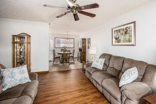 living room with ceiling fan, a textured ceiling, and wood finished floors